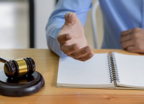 Close-up shot of Hammer on the table and lawyer introducing law, Concept of law.